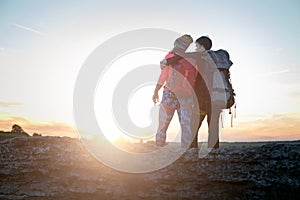 Picture of photo from back of hugging man and woman of tourists on hill during summer