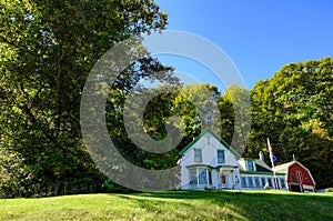 Picture-postcode view of an old american home and barn.