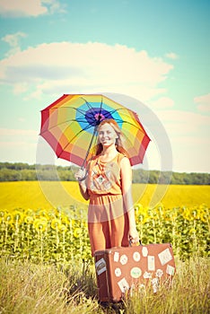 Picture of pretty female holding rainbow umbrella