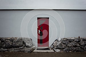 a red door leading to a red brick wall photo