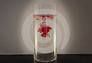 Red food coloring in water in a vase