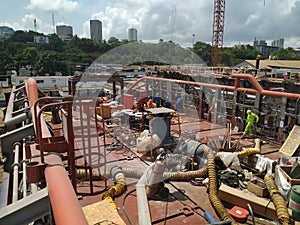 Picture of repairs, maintenance, modifications ongoing on a vessel main deck in a ship yard