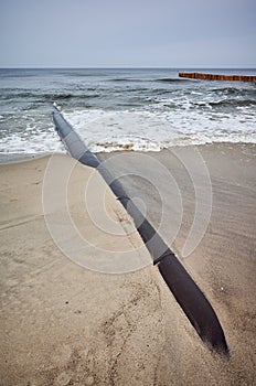 Rusty pipeline on a beach