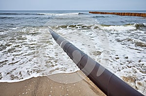 Rusty pipeline on a beach