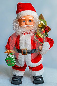 Picture of a Santa Claus doll with gifts and white background. Big Copy space concept New Year`s market banner, poster