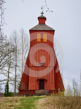 Picture with Scandinavian-style red very old wooden house, wooden tile roof photo