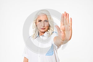 Picture of serious mature woman with grey hair looking strictly