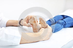 Little girl in clinic having a checkup with orthopaedist photo