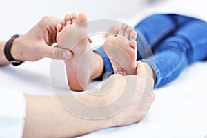 Little girl in clinic having a checkup with orthopaedist photo