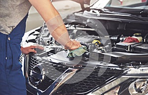 Picture showing muscular car service worker repairing vehicle