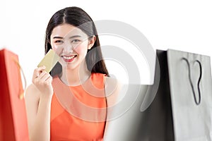 Picture showing smart attractive young asian girl holding credit card with happiness and joyful.