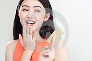 Picture showing smart attractive young asian girl holding credit card with happiness and joyful.