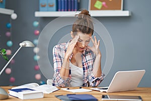 Tired female student learning till late at home