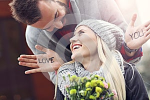 Picture showing young couple with flowers dating in the city