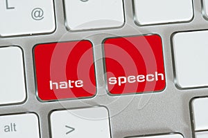 Computer and buttons for hate language photo