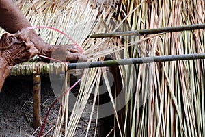 Picture shows how to make a panel vetiver for hut roof, handwork crafts of panel vetiver for hut roof, straw roof hut