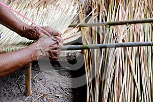 Picture shows how to make a panel vetiver for hut roof, handwork crafts of panel vetiver for hut roof, straw roof hut