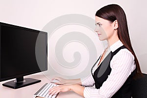 Picture of smiling businesswoman using her compute photo