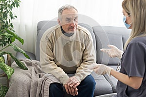 Picture of smiling nurse assisting senior man