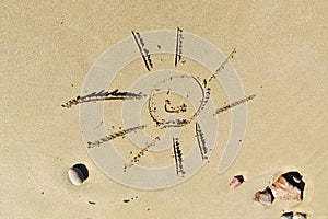 Picture of the smiling sun on sand