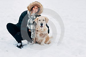 Picture of smiling woman with labrador in winter park