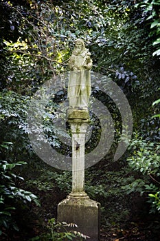 Statue in the middle of a green garden at Magnolia plantation in Charleston South Carolina