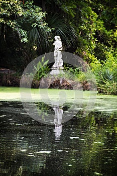 Statue in the middle of a green garden at Magnolia plantation in Charleston South Carolina