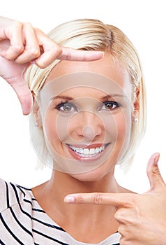 Picture this. Studio portrait of a beautiful young woman framing her face with her hands.