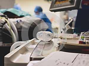 Picture of surgeon in background in operating theatre.