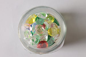 Picture of transparant jar with colorful gem stone toys in it