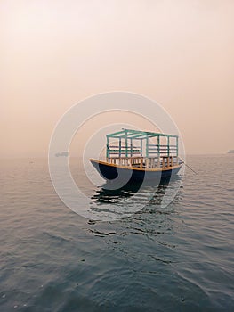 Picture of a travel boat floating in deep water in a vast lake