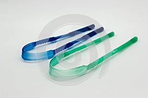 A picture of tungue cleaner isolated on white background