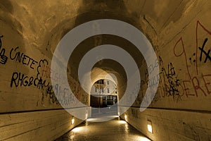 Picture of a tunnel with graffiti writings about vindication, educational strike, rights