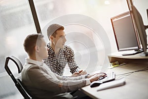 Picture of two businessmen working on computer