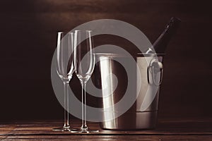 Picture of two empty wine glasses, bottle of wine