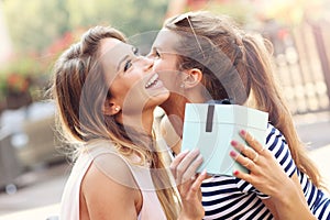 A picture of two girl friends making a surprise birthday present