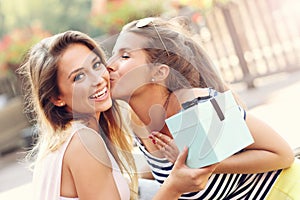 A picture of two girl friends making a surprise birthday present