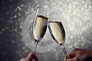 Picture of two glasses with champagne on gray background
