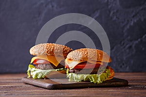 Picture of two hamburgers on wooden table