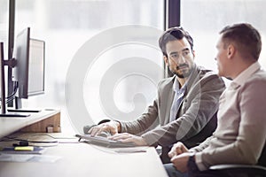 Picture of two young businessmen having discussion