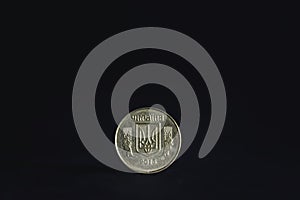 Selective blur on a ukrainian hryvnia coin with Ukraine written in ukrainian and the ukrainian trident coat of arms isolated on a