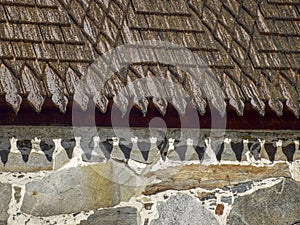 Picture of a very old stone house, fragments of wooden tile roof photo