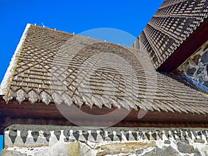 Picture of a very old stone house, fragments of wooden tile roof photo