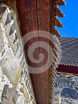 Picture of a very old stone house, fragments of wooden tile roof photo