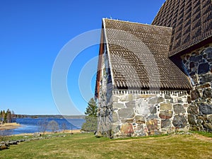 Picture with very old stone house, interesting wooden tile roof photo