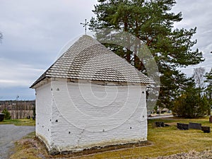 Picture with very old stone house, interesting wooden tile roof photo