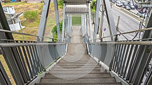 A picture of the walkway down one of the overpasses in a large city.