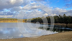 A beautiful little lake next to Frankfurt at a cold but sunny day in winter with beautiful cloudscape.