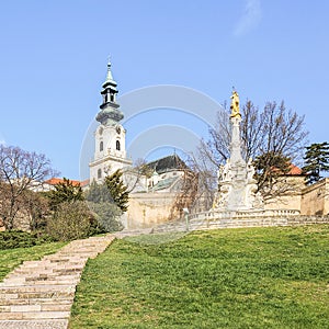 In the foreground is a baroque plague pillar. The pillar was installed under the Nitra Castle in 1750, Slovakia.