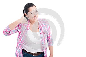 Picture of woman making a call me gesture